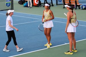 GT Tech works with Carole Lee (center) and Kate Sharabura between points of a win over Boston College